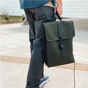 Backpack is cut in Rains’ signature waterproof PU fabric. Dark green large